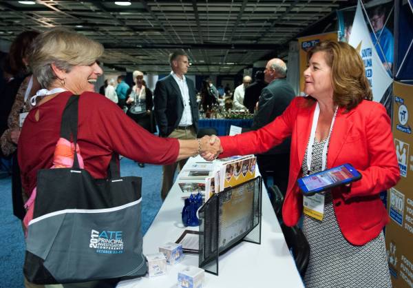 Emery DeWitt  Program Manager disseminating information at SCATE booth
